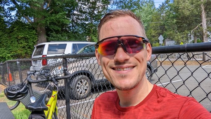 Steven on a ride, smiling in cycling sunglasses